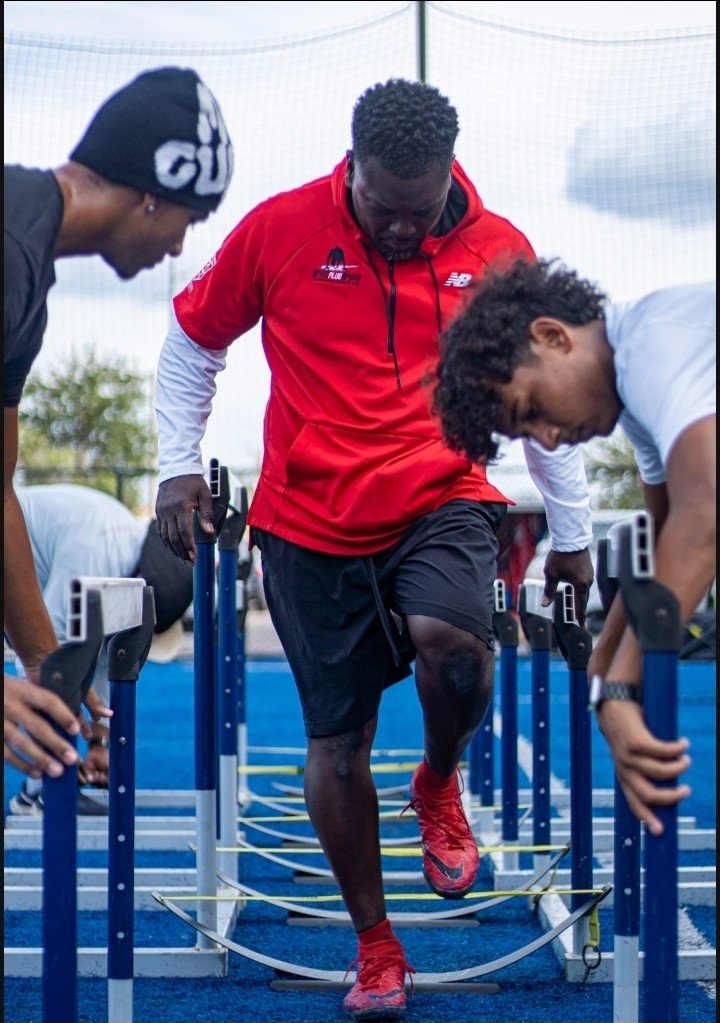 Coach Boris BoJack Jackson leading a hurdle drill with two athletes at Speed Plus practice